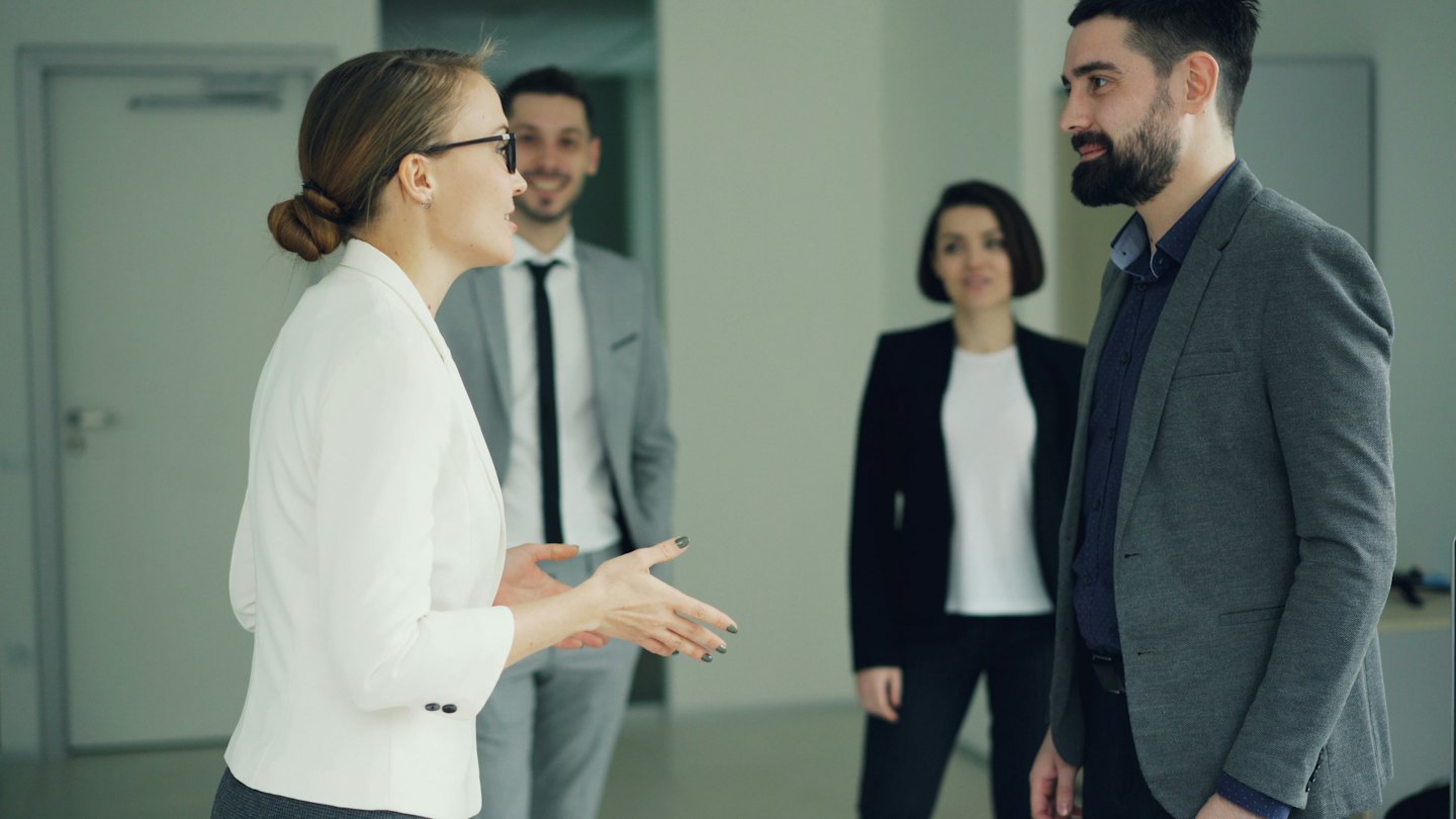 Business professionals discussing ideas in a modern office.