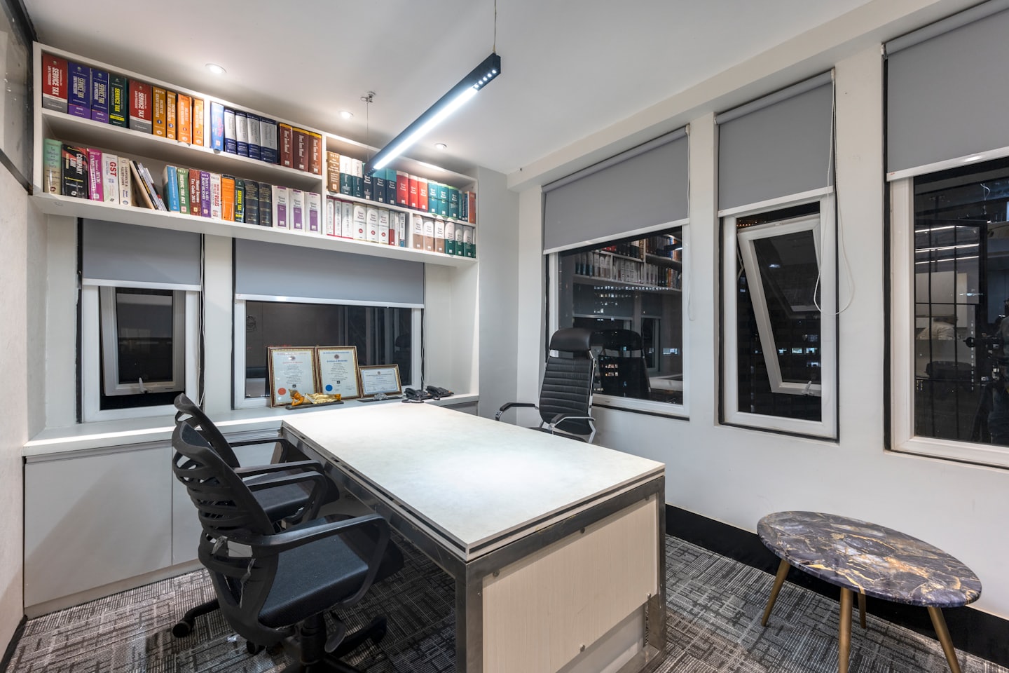 Professional office with a large desk and law library bookshelves.